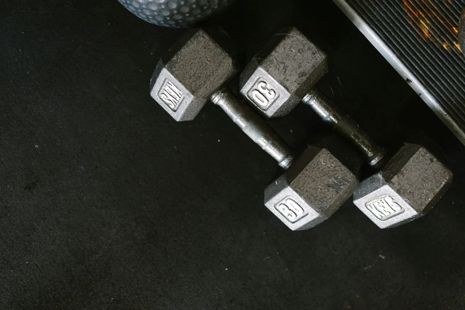 Resistance bands, dumbbells, and an exercise mat for a starter home gym