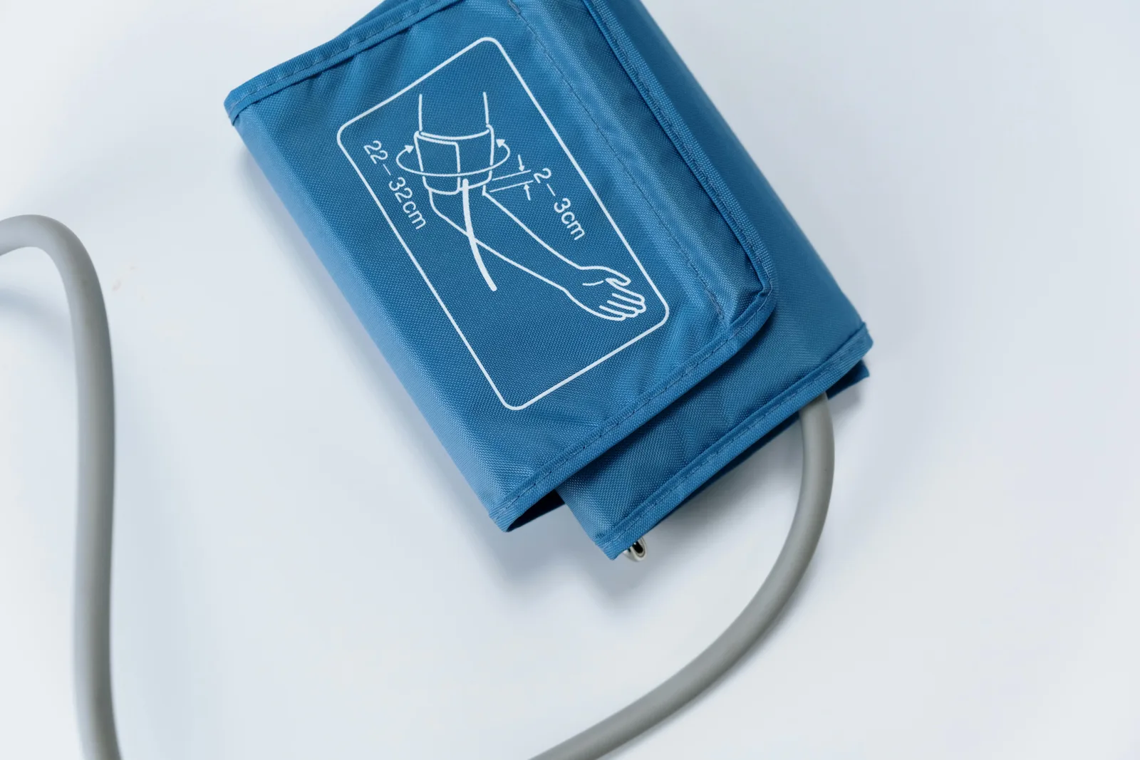 Blood pressure cuff wrapped around an upper arm with the size range visible