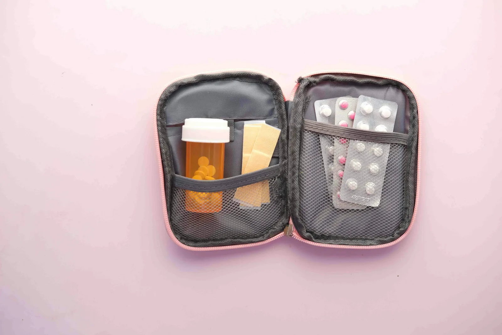 Open first aid kit with organized bandages, gauze, gloves, tape, and basic supplies